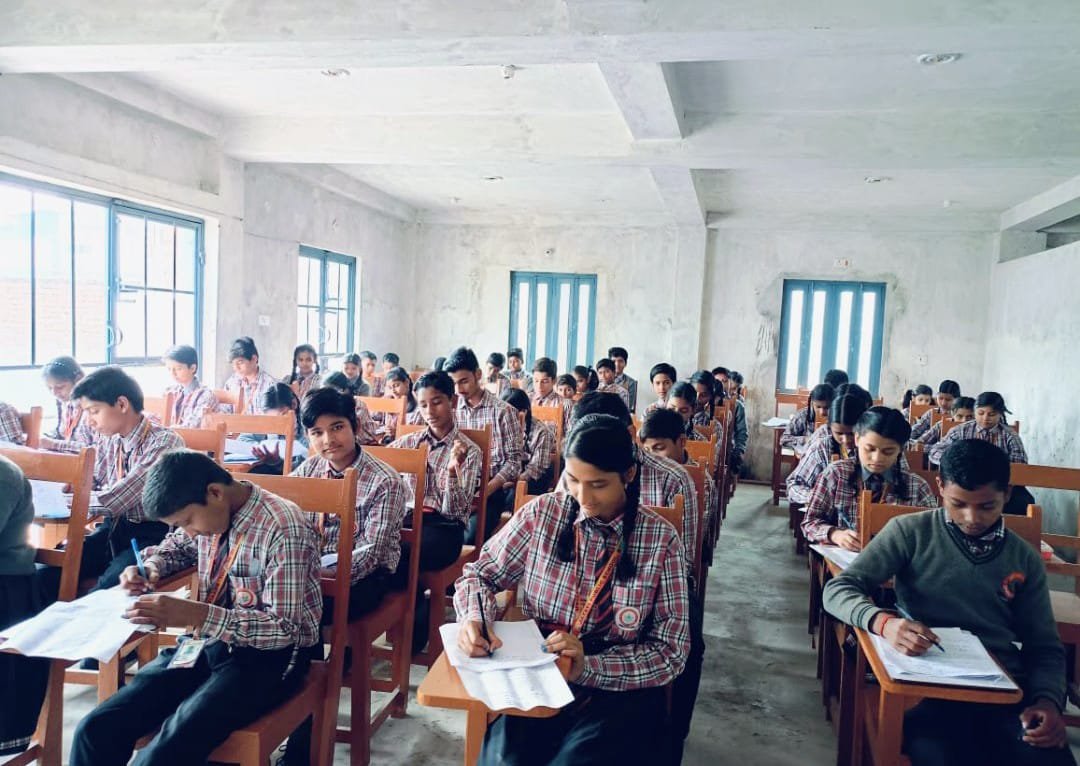 Students writing exam in classroom