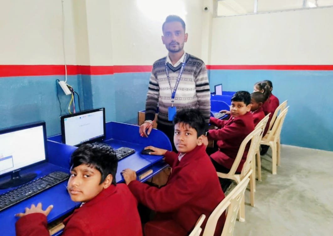 Teacher and students in computer science lab