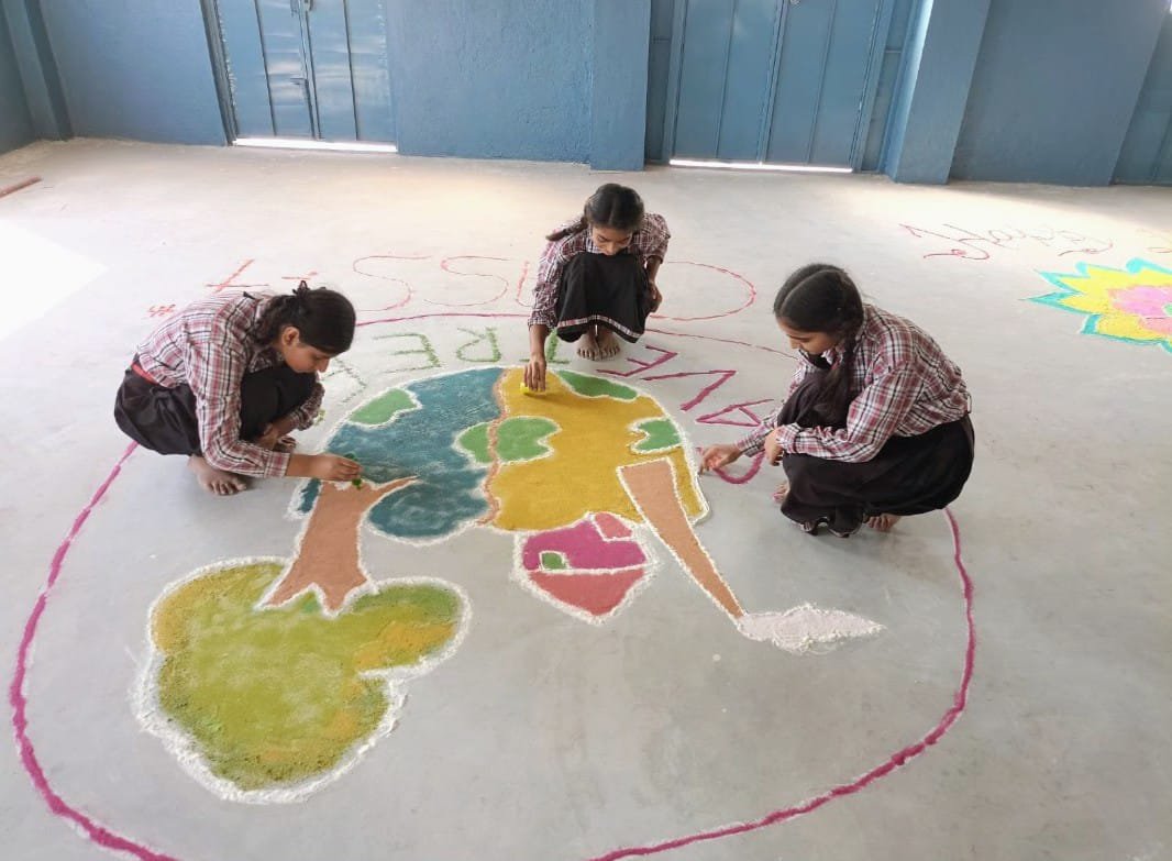 Girls making a Save Tree rangoli