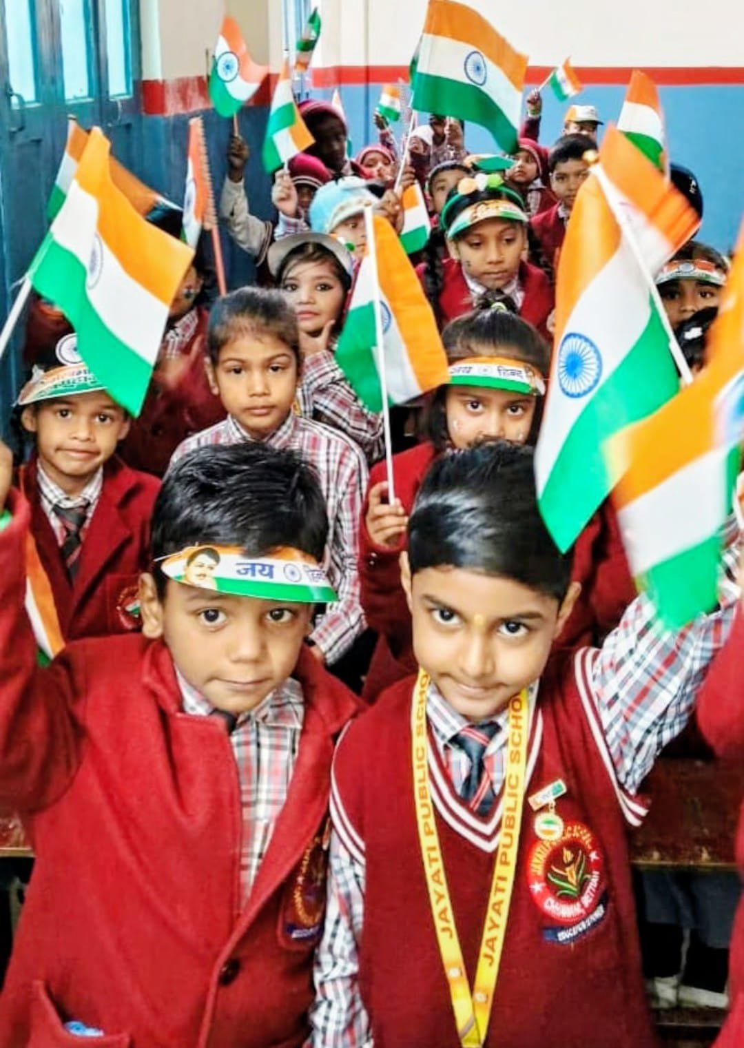 Children in uniform waving flags